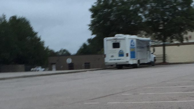 SNAP-NC mobile veterinary clinics travel to make spaying and neutering more accessible. This is a SNAP van in a Zebulon NC store parking lot. Photo: Kay Whatley.